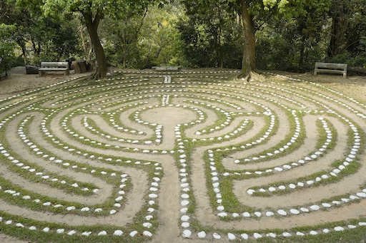 Circular stone labyrinth in garden