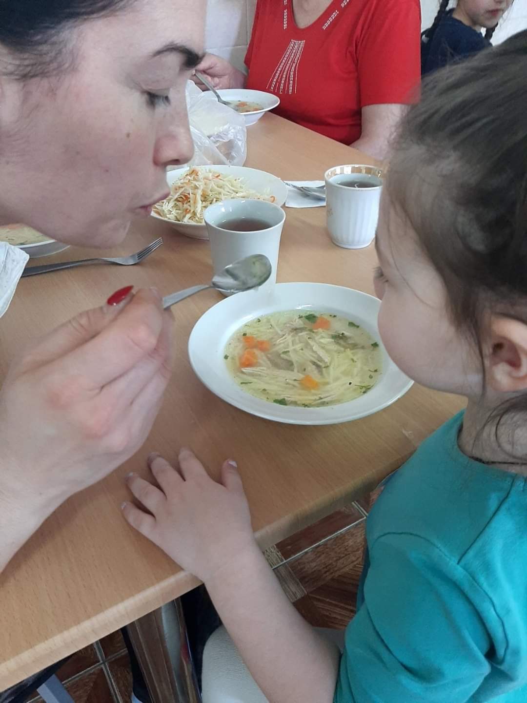 Ukrainian mother and daughter sharing a meal.