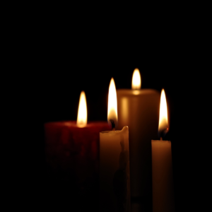 Candles burning in dark