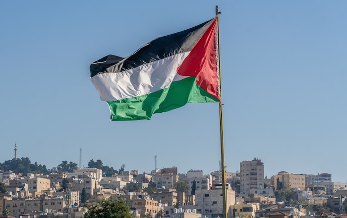 The large Palestinian flag (flag of Palestine) is waiving above the city. The Israel-Palestine Working Group