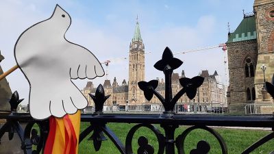 Ottawa parliament building with paper dove in forefront