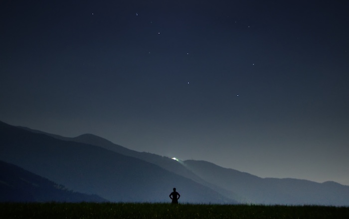 Person standing under stars