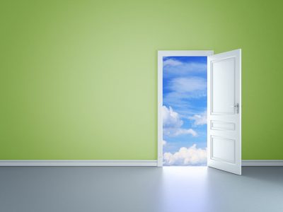 Open door, green wall, blue sky