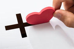 Inserting a red heart into a cross slot